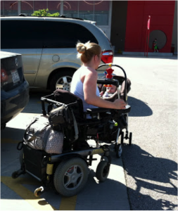 mother pushes baby in stroller while in wheelchair