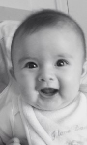 Black and white photo of baby girl smiling