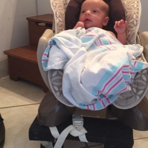 Photo of baby in seat on top of dolly