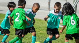 Photo of young children playing soccer