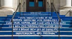 Stairs painted with quote by President George H.W. Bush: With today's signing of the landmark Americans for Disabilities Act, every man, woman, and child with a disability can now pass through once-closed doors into a bright new era of equality, independence, and freedom.