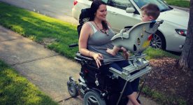 Mother in power wheelchair uses a specialized seat that attaches to her wheelchair. Son is able to sit facing her. Seat is from a bicycle.