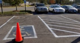 Accessible parking space blocked by orange cones